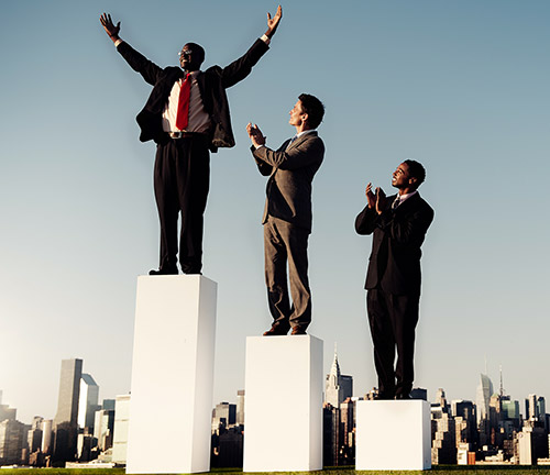 Men in suits stand on a podium