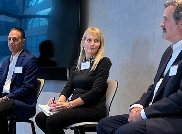 Georganne Goldblum sits on a panel with CEOs discussing transferable value in February 2023