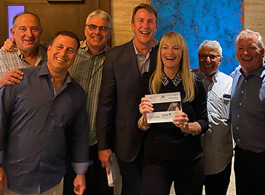 Georganne poses for photo with business owners who successfully exited.