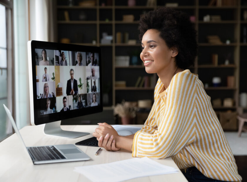 Happy African American employee talking on video conference call