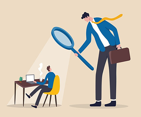 Cartoon image of a giant manager holding a magnifying glass over an employee sitting at their desk.