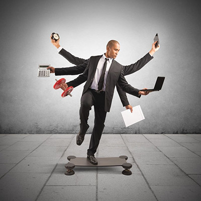 Man with 4 extra arms and standing on a balance board, demonstrating the impoortance of flexibility in business.