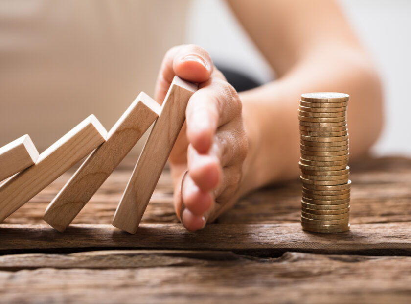 Close-up Of A Businesswoman's Hand Stopping Falling Blocks