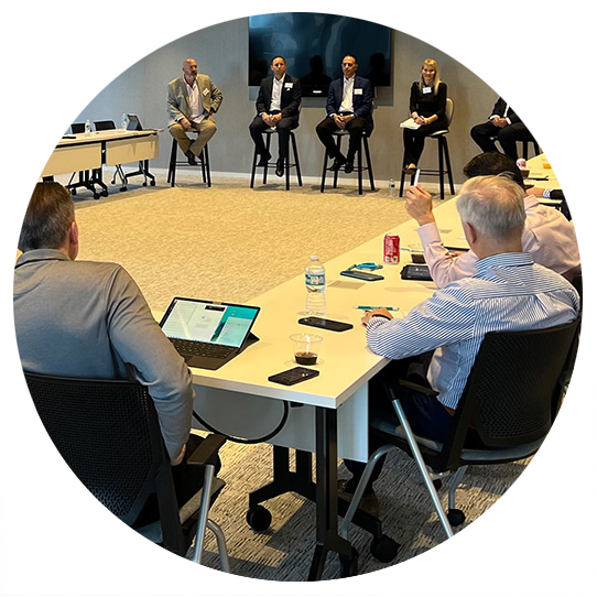 Gair Maxwell speaks in front of an audience with hands raised.