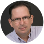 Headhot of Jess Coburn in a dress shirt, wearing glasses.